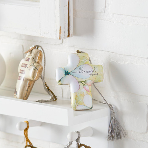 cross shaped trinket with flowers reading Blessed Beyond