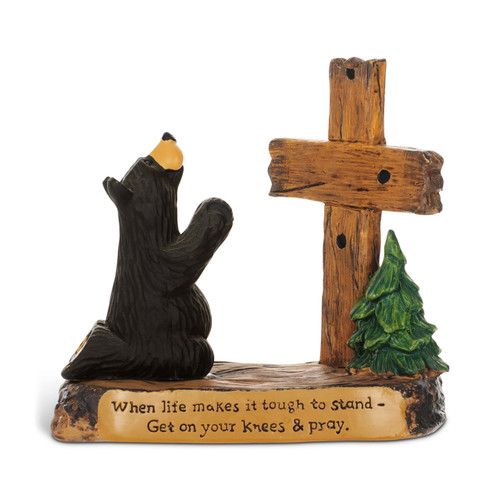 A black bear figurine kneeling in prayer before a wood cross. The base says "When life makes it tough to stand - Get on your knees & pray".
