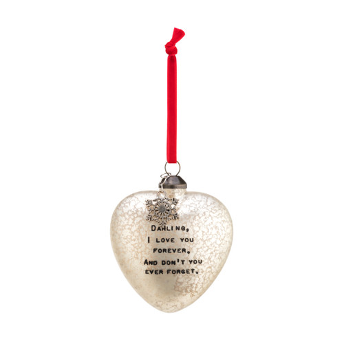 A frosted glass heart shaped ornament with a silver snowflake charm, a red velvet string, and "Darling, I love you forever. And don't you ever forget."