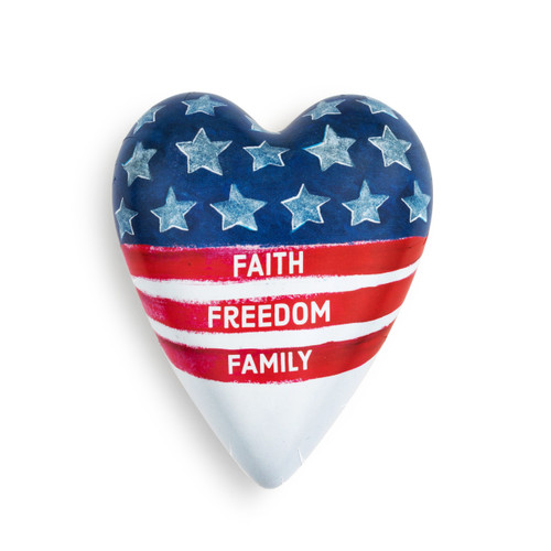 A white Art Heart with the top half blue, covered with blue stars, and three red stripes below, that read Faith Freedom Family"."