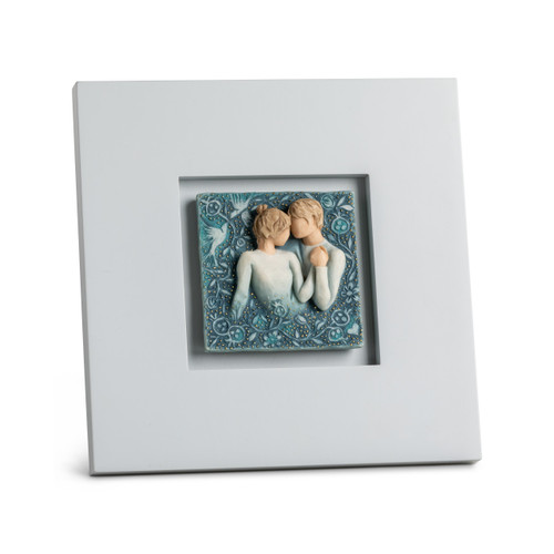 Dove gray wood frame enhances inset carved plaque of embracing couple, birds and flowers, painted in blue ombre and gold dots
