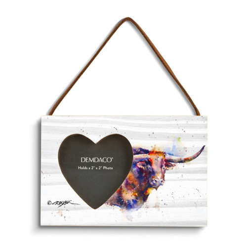 A rectangular wood hanging frame with a heart shaped 2 inch photo opening next to a watercolor image of a longhorn.