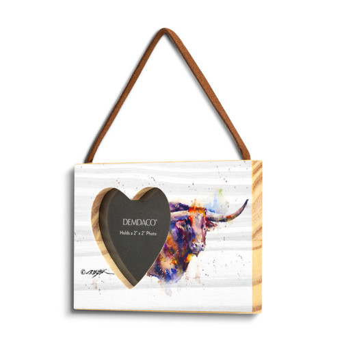 A rectangular wood hanging frame with a heart shaped 2 inch photo opening next to a watercolor image of a longhorn, displayed angled to the left.