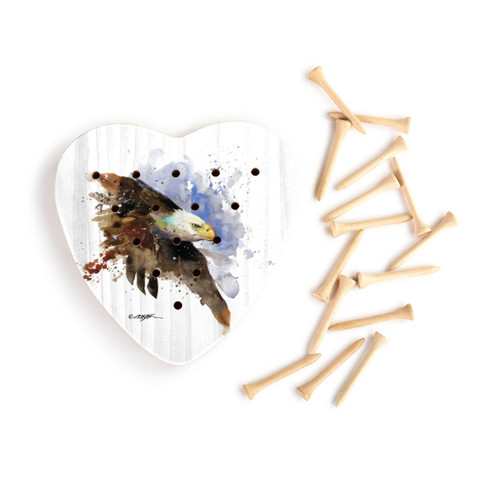 A heart shaped wood peg game with a painting of a bald eagle, next to a set of wood pegs.