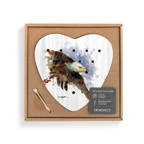 A heart shaped wood peg game with a painting of a bald eagle, displayed in a packaging box with a product tag attached.