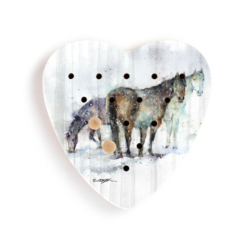 A heart shaped wood peg game with a watercolor painting of three horses, with two wood pegs in it.