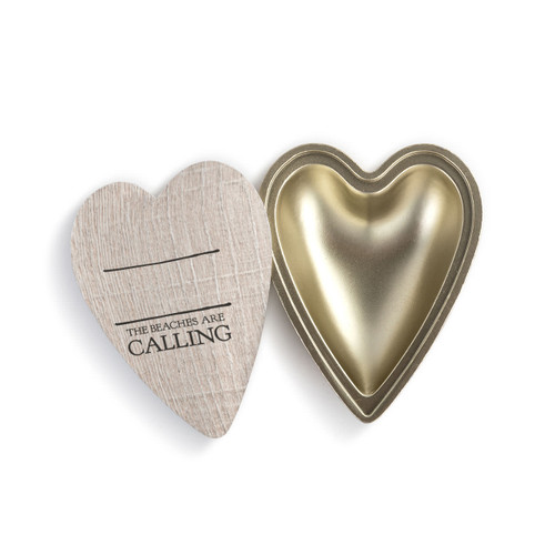 A heart shaped container with a wood grain lid that says "The Beaches are Calling" under two black lines, with the lid offset to the base.