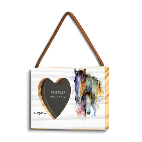 A rectangular wood hanging frame with a heart shaped 2 inch photo opening next to a watercolor image of a pair of horses, displayed angled to the left.
