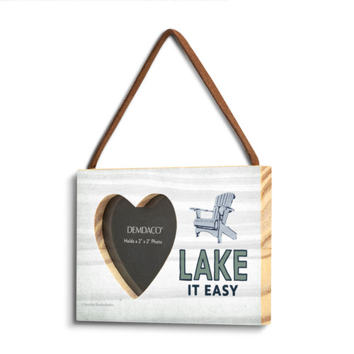A light wood rectangular hanging frame with a 2 inch heart shaped opening for a photo next to an image of Adirondack chair and the saying "Lake It Easy" angled to the left.