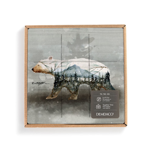 A square wood tic tac toe board with a watercolor image of a polar bear, displayed in a packaging box with a product information tag.