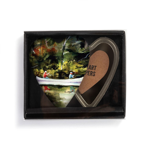 Heart shaped keeper with a watercolor image of a canoe on the river on the lid, displayed in a packaging box.