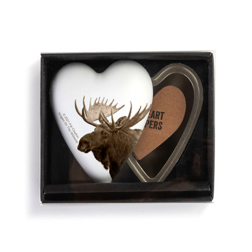 A heart shaped container with a moose on a white background, shown with the lid offset to the base in a packaging box.