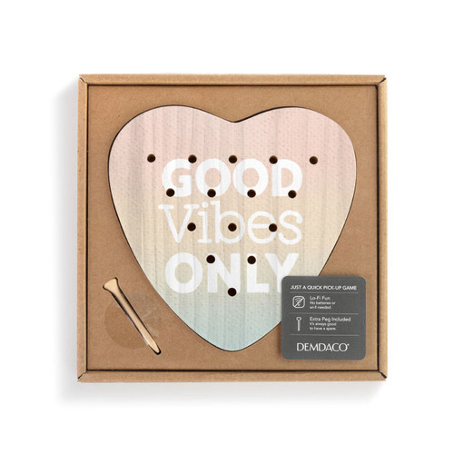 A wood heart shaped peg game that says "Good Vibes Only" shown in a cardboard packaging box with a product information tag.