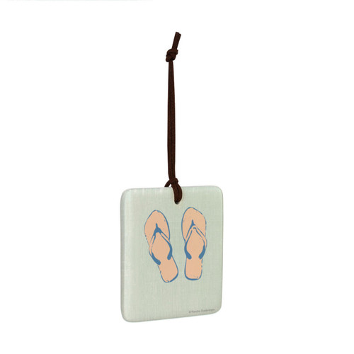 A square hanging ornament with a pair of flip flops on a light green background angled to the right.