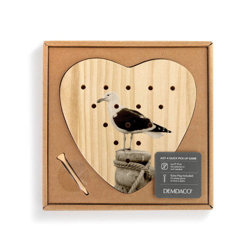 A heart shaped wood peg game that has the image of a sea gull, shown in a packaging box with a product information tag.