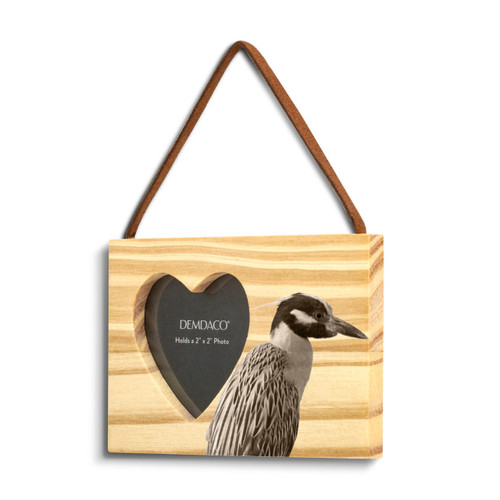 A rectangular wood hanging ornament with a heart shaped 2 inch photo opening next to an image of a heron, displayed angled to the left.