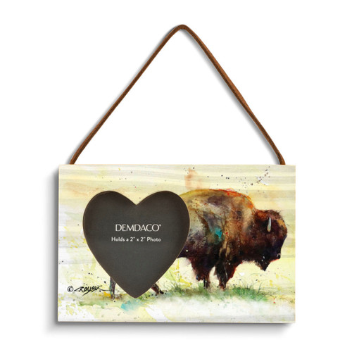 A rectangular wood hanging frame with a heart shaped 2 inch photo opening next to a watercolor image of a standing buffalo.