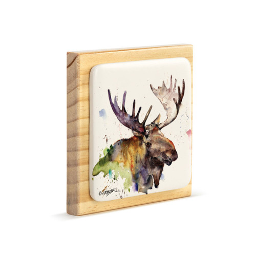 A square wood plaque angled to the right with a tile attached that has a watercolor image of a moose.