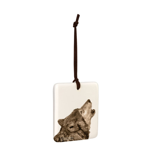 A white square tile hanging ornament with the image of a howling wolf, displayed angled to the right.