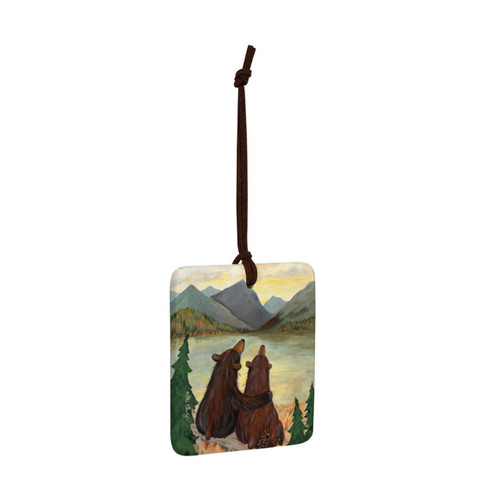 A square ceramic hanging ornament with a painting of two black bears watching the sunset, displayed angled to the right.