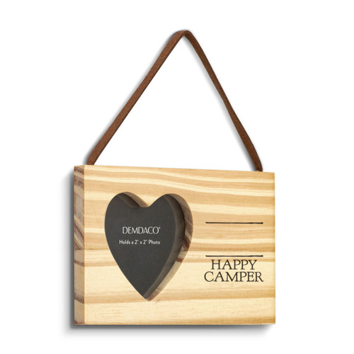 A rectangular hanging wood ornament with a heart shaped two inch photo opening next to the saying "Happy Camper" under two black lines with room for personalization, displayed angled to the right.