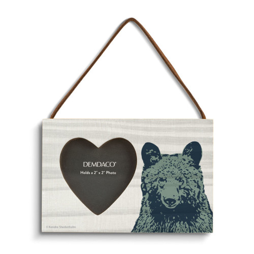 A hanging wood rectangular frame with a 2 inch heart shaped opening for a photo next to an image of a bear's head.