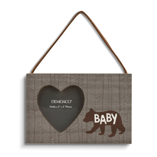 A hanging brown rectangular wood frame with a 2 inch heart shaped opening for a photo with a silhouette image of a bear that says "Baby".