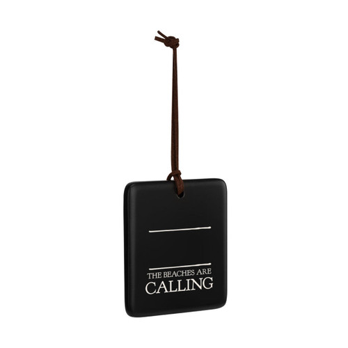 A square black hanging ornament that says "The Beaches are Calling" in white under two white lines with room for personalization, displayed angled to the right.