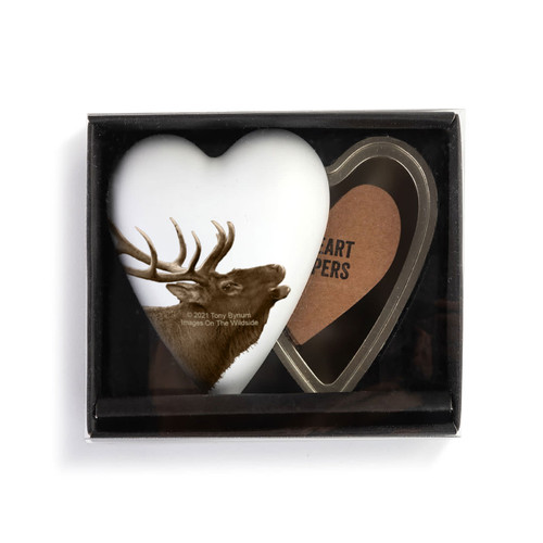 A heart shaped container with an elk on a white background, shown with the lid offset to the base in a packaging box.