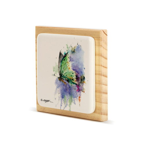 A square wood plaque angled to the left with a tile attached that has a watercolor image of a green butterfly.