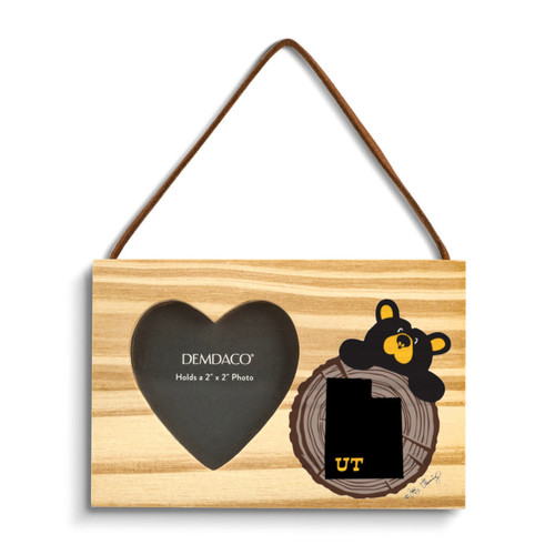 A rectangular wood hanging ornament with a 2x2 inch heart shaped photo opening next to an image of a black bear peeking over a wood stump with Utah on it.