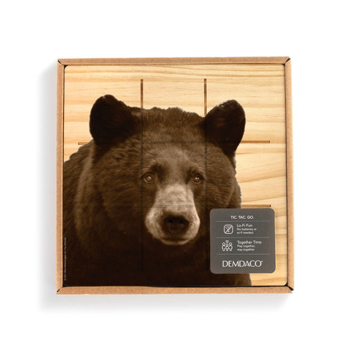 A square wood board for tic tac toe with an image of a bear, shown in a packaging box with a product information tag.