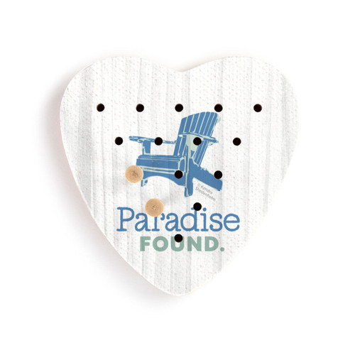 A white heart shaped wood peg game with a blue Adirondack chair and the saying "Paradise Found", shown with two wood pegs in the holes.