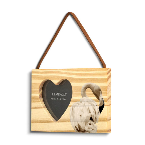A rectangular wood hanging ornament with a heart shaped 2 inch photo opening next to an image of a flamingo, displayed angled to the left.