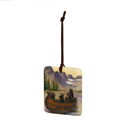 A square ceramic hanging ornament with a painting of two bears in a canoe, displayed angled to the left.