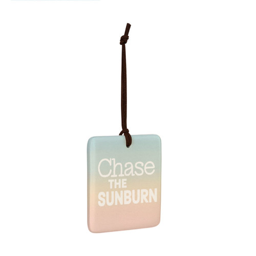 A square tile hanging ornament with sunset colors and says "Chase the Sunburn", displayed angled to the right.