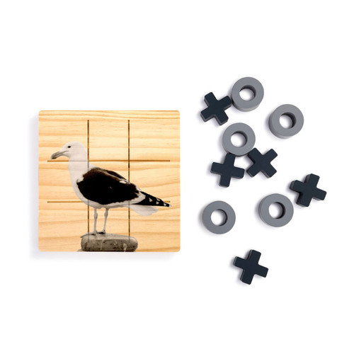 A square wood board for tic tac toe with the image of a sea gull, shown next to a set of X's and O's in gray and black.