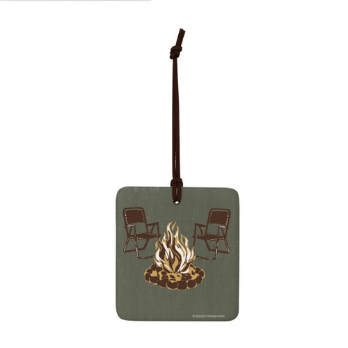 A square dark green hanging ornament with a bonfire and two camp chairs.