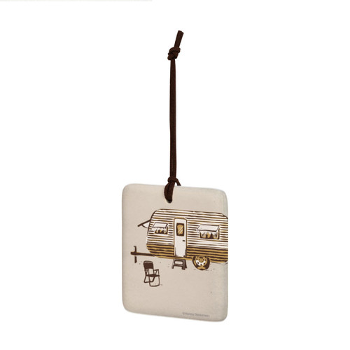 A square hanging ornament with a brown and white camper on a tan background angled to the left.