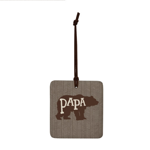 A square hanging ornament with a bear silhouette that says "Papa" on a brown geometric background.