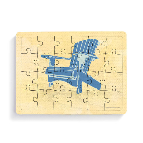 A rectangular wood 24 piece postcard puzzle with a blue Adirondack chair on a yellow background.