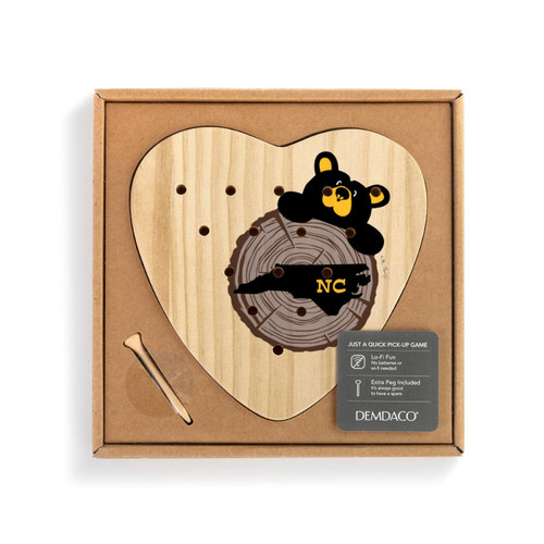 Heart shaped wood peg game with a black bear peeking over a wood stump with North Carolina on it, shown in a packaging box with a product information tag.