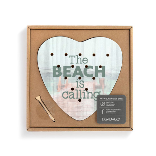 A heart shaped wood peg game with a lake pier scene that says "The Beach is calling", displayed in a packaging box with a product information tag.