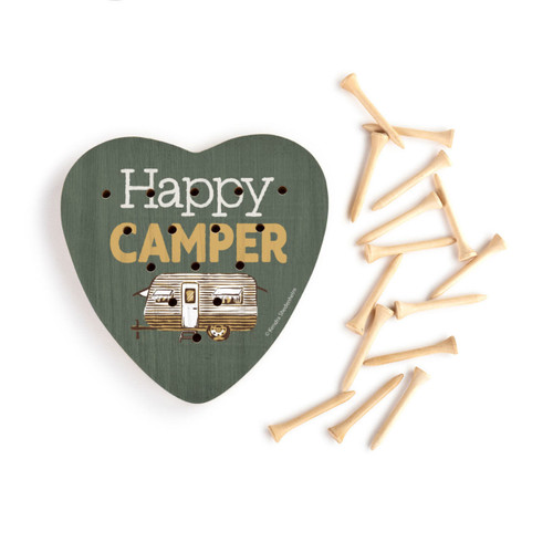 A dark green heart shaped wood peg game with a camper van and the saying "Happy Camper", next to a set of wood pegs.