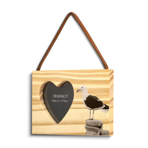 A rectangular wood hanging ornament with a heart shaped 2 inch photo opening next to an image of a sea gull, displayed angled to the left.