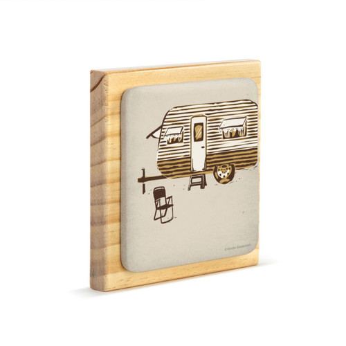 A square wood plaque with a tile attached that has an image of a brown and white camper on a tan background on an angle to the right.