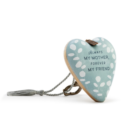 Heart shaped sculpture with a silver tassel and metal key attached. The heart is light green with white leaves and says "Always My Mother, Forever My Friend", displayed angled to the right.