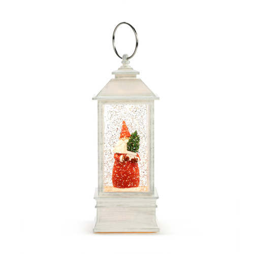 White lit musical lantern with a Santa figure inside holding a small tree.
