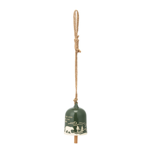 A dark green stoneware bell on a jute hanger with a mountain scene that says "Be Wild as the Wind and Shine Like the Stars", displayed angled to the left.