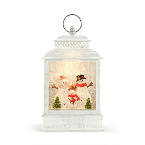 A white lit lantern with a snowman family in a snowy scene inside.